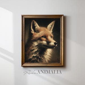 Op de afbeelding: Een ingelijst portret in vintage-stijl van een vos. Het kunstwerk toont de vos in profiel, met roodbruine vacht en een donkere achtergrond. De lijst heeft een warme bruine kleur. De tekst "Realm ANIMALIA" staat onderaan de lijst.