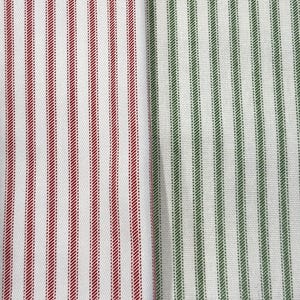 May include: Close-up of two fabric samples. One features vertical red stripes on a white background. The other has vertical green stripes on a white background. The fabric has a textured appearance.
