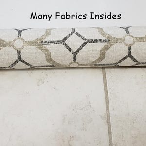 May include: A close-up of a rolled-up fabric with a geometric pattern in shades of beige and gray. The fabric is labeled "Fabric 7" and the text "Many Fabrics Insides" is visible above the fabric.