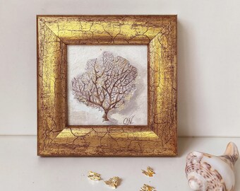 May include: A framed painting of a coral-like tree in shades of white, brown, and lavender. The artwork is set within a gold-colored, textured frame. The painting is signed "ON" in the lower right corner. Decorative gold leaf flakes and a seashell are also present.