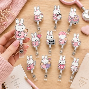 May include: A collection of eleven acrylic badge reels featuring a white cartoon rabbit dressed as a nurse in various poses, including holding a baby, a bottle, a clipboard, a stethoscope, an ultrasound, a medical kit, and a heart-shaped sign.