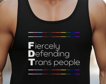 May include: Black tank top with the acronym "FDT" in white letters, standing for "Fiercely Defending Trans People". The letters are separated by horizontal lines with rainbow colors.