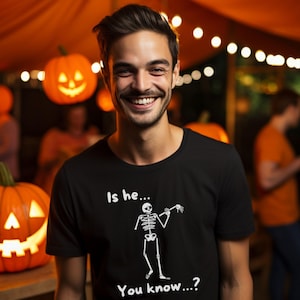 Funny Gay Halloween Shirt with Skeleton and Limp Wrist Is He You Know Queer Pride Shirt for LGBTQ Spooky Season Costume or Gift