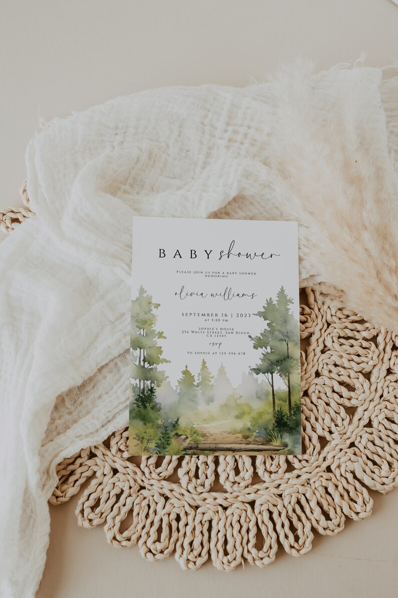 May include: A watercolour illustration of a forest path with a baby shower invitation overlay. The invitation reads "BABY shower" and includes the text "Please join us for a baby shower honouring Olivia Williams, September 16, 2023, at 1:00 PM, Sophie's House, 216 White Street, San Diego, CA 12345, RSVP to Sophie at 123-456-678".