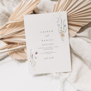 May include: A wedding invitation with a floral design featuring a bouquet of purple, pink, and white wildflowers. The invitation reads "Lauren and Daniel" and includes the date "Saturday, October 7, 2023" and the location "The White Inn, 274 Whitelaw Drive, CA 91745".