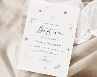 May include: A white invitation card with the words "Baptism" and "Grace Duncan" in elegant script. The card is decorated with delicate pink floral accents and a small gold cross. The text includes the date, time, and location of the event.