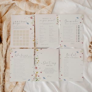 May include: A set of six printable bridal shower game cards with floral designs. The games include "Bridal Bingo", "What's in your purse?", "Guess who - Bride or Groom", "Who knows the bride best?", "Don't say bride", and "Bridal Word Scramble".