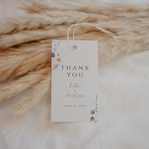 May include: White thank you card with a floral design and the text "Thank You Belle + Christian April 9, 2024".