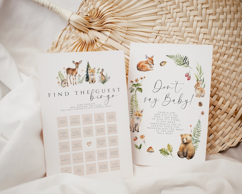 May include: Two printable baby shower games. One game is "Find the Guest Bingo" with woodland animal illustrations. The other game is "Don't Say Baby!" with a bear and bunny illustration. Both games have text on a white background.