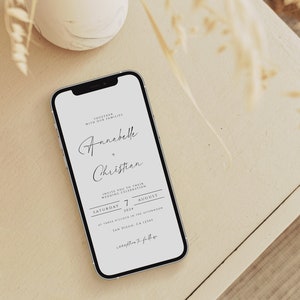 May include: A white smartphone with a black screen displaying a wedding invitation for Annabelle and Christian. The invitation is for a wedding celebration on Saturday, August 7, 2024, at three o'clock in the afternoon in San Diego, CA 12345.