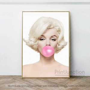May include: A black and white portrait of a woman with blonde hair blowing a pink bubble. The background is white.