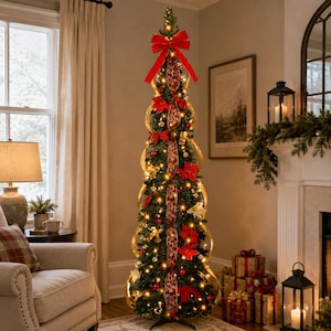 May include: A tall, slender, pre-lit artificial Christmas tree decorated with a long, vertical red and gold patterned ribbon, a large red bow at the top, red poinsettia flowers, gold ornaments, and warm white string lights.