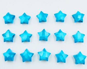 May include: A row of 18 blue origami stars arranged in a grid pattern on a white background.