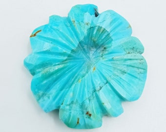 May include: A carved turquoise flower pendant with a blue-green color and a slightly irregular shape.