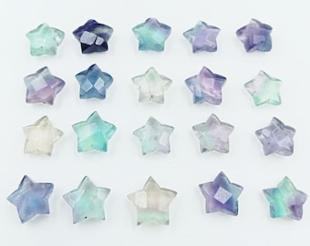 May include: Twenty-one star-shaped fluorite crystals in various shades of blue, green, and purple. The crystals are faceted and have a translucent appearance.
