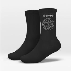 May include: A pair of black crew socks with a white Viking compass design and the text "MR R PAM". The socks are made of a soft material and are suitable for everyday wear.