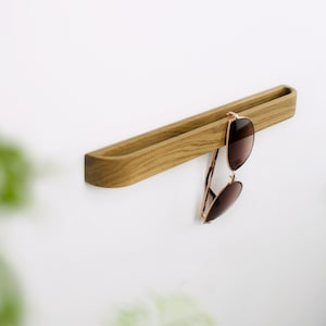 Modern glasses wall hook made of natural oak wood, no drilling required, self adhesive wooden holder for organizing reading glasses in hallway, bathroom or workspace