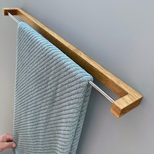 oak towel rack, wooden towel holder, wall mounted rack, minimalist wood hanger, Scandinavian design, modern bathroom decor, solid oak wood, handmade towel rack, eco-friendly bathroom, natural wood accessory, nordic home style, sleek wood rail, bathroom wall hook, functional wood decor, rustic modern rack, minimal bathroom storage, minimalist bathroom organizer, simple wood towel rail, wooden bathroom accessory, space-saving towel rack, zen bathroom decor, modern oak bathroom, clean design,