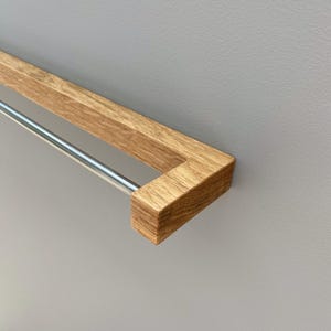 oak towel rack, wooden towel holder, wall mounted rack, minimalist wood hanger, Scandinavian design, modern bathroom decor, solid oak wood, handmade towel rack, eco-friendly bathroom, natural wood accessory, nordic home style, sleek wood rail, bathroom wall hook, functional wood decor, rustic modern rack, minimal bathroom storage, minimalist bathroom organizer, simple wood towel rail, wooden bathroom accessory, space-saving towel rack, zen bathroom decor, modern oak bathroom, clean design,