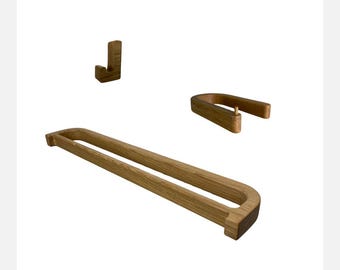 May include: A set of three wooden bathroom accessories, including a towel bar, a hook, and a toilet paper holder. The accessories are made of natural wood and have a simple, modern design.