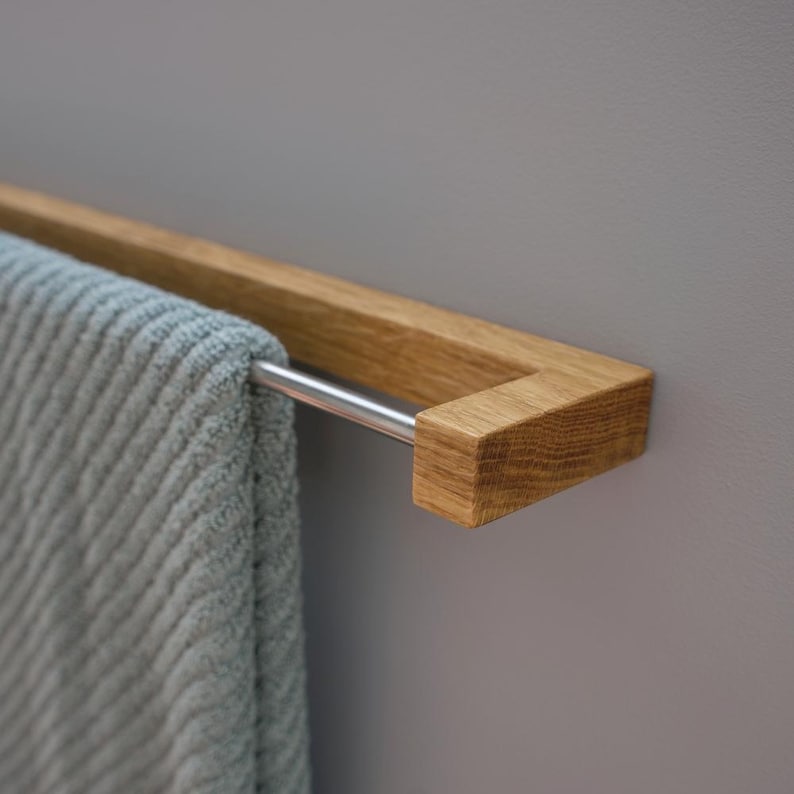 oak towel rack, wooden towel holder, wall mounted rack, minimalist wood hanger, Scandinavian design, modern bathroom decor, solid oak wood, handmade towel rack, eco-friendly bathroom, natural wood accessory, nordic home style, sleek wood rail, bathroom wall hook, functional wood decor, rustic modern rack, minimal bathroom storage, minimalist bathroom organizer, simple wood towel rail, wooden bathroom accessory, space-saving towel rack, zen bathroom decor, modern oak bathroom, clean design,