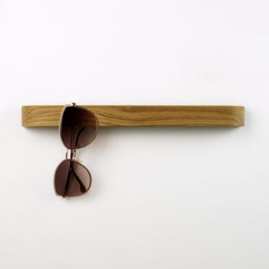 Wooden glasses hanger with clean modern design, made from solid oak, self adhesive installation, practical reading glasses organizer for office, bathroom or entryway