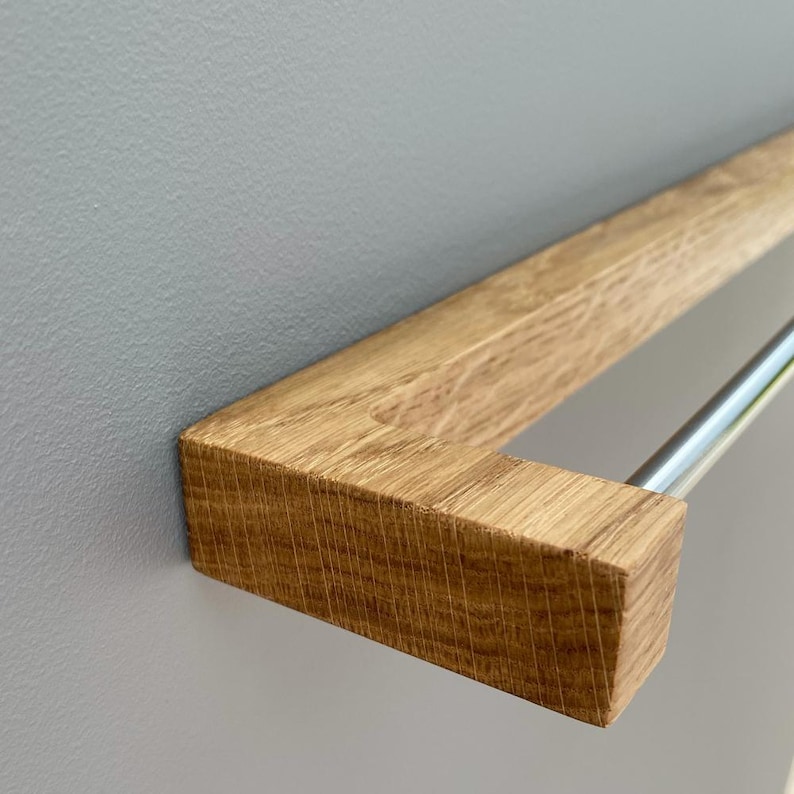 oak towel rack, wooden towel holder, wall mounted rack, minimalist wood hanger, Scandinavian design, modern bathroom decor, solid oak wood, handmade towel rack, eco-friendly bathroom, natural wood accessory, nordic home style, sleek wood rail, bathroom wall hook, functional wood decor, rustic modern rack, minimal bathroom storage, minimalist bathroom organizer, simple wood towel rail, wooden bathroom accessory, space-saving towel rack, zen bathroom decor, modern oak bathroom, clean design,