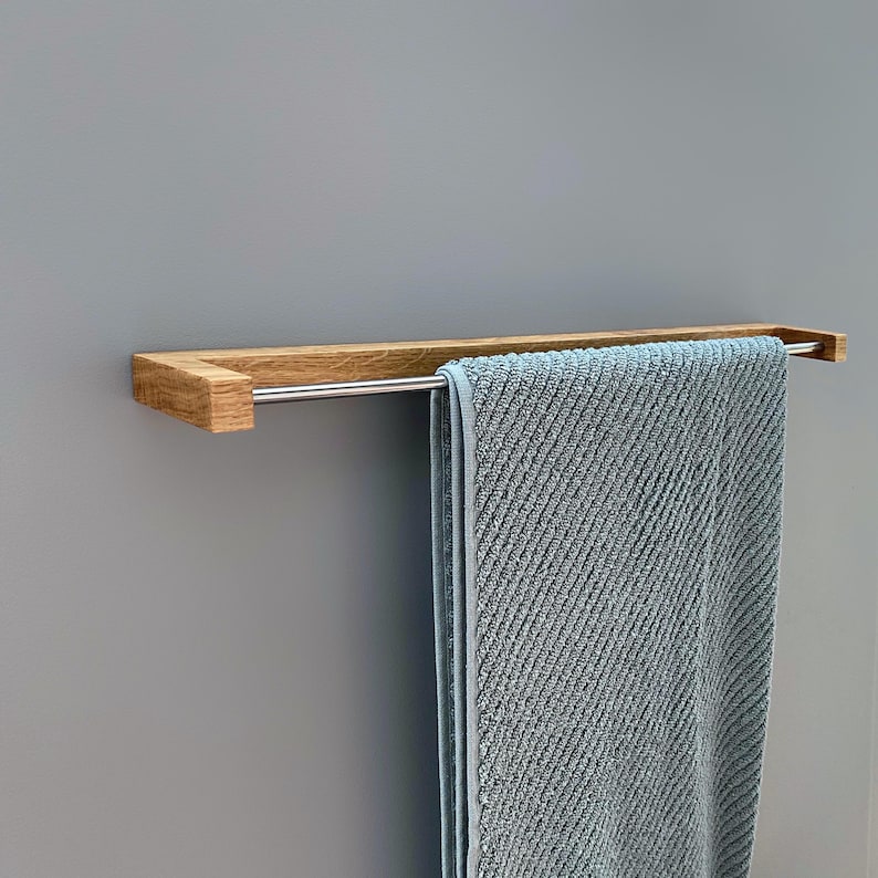 oak towel rack, wooden towel holder, wall mounted rack, minimalist wood hanger, Scandinavian design, modern bathroom decor, solid oak wood, handmade towel rack, eco-friendly bathroom, natural wood accessory, nordic home style, sleek wood rail, bathroom wall hook, functional wood decor, rustic modern rack, minimal bathroom storage, minimalist bathroom organizer, simple wood towel rail, wooden bathroom accessory, space-saving towel rack, zen bathroom decor, modern oak bathroom, clean design,