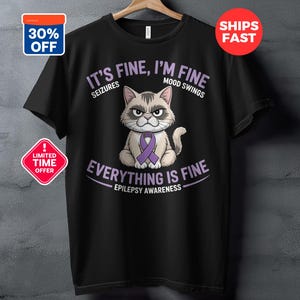 May include: Black t-shirt featuring a grumpy cat wearing a purple awareness ribbon. The shirt has text that reads "It's Fine, I'm Fine" with "Seizures" and "Mood Swings" above the cat, and "Everything is Fine" with "Epilepsy Awareness" below.