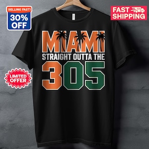 May include: Black t-shirt with the text "MIAMI STRAIGHT OUTTA THE 305" in orange, white, and green. The word "MIAMI" has palm tree silhouettes. The shirt is hanging on a wooden hanger.