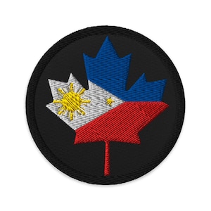 May include: Embroidered patch featuring a maple leaf design with the colors of the Philippines flag. The leaf is divided into blue, white, and red sections, with a yellow sun emblem. The patch has a black border.
