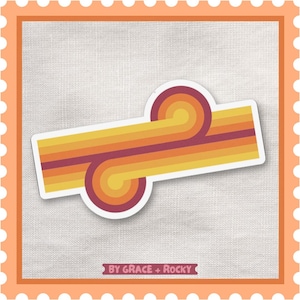 May include: A sticker with a retro design featuring a series of horizontal stripes in shades of yellow, orange, and burgundy. The design includes two rounded swirl shapes. The text "BY GRACE + ROCKY" is at the bottom.