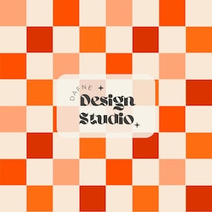 May include: A square pattern design in shades of orange, red-orange, and cream. The design features a checkerboard pattern with the text "DAFNE + Design Studio" in a white rounded rectangle.