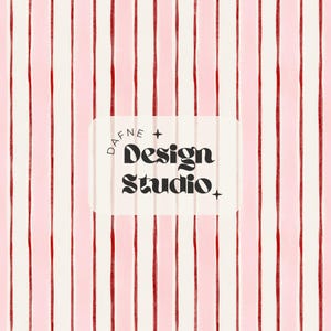 May include: A patterned background featuring vertical stripes in cream, light pink, and red. A white rectangle with the text "DAFNE + Design Studio" in a black, stylized font is centered. The design has a modern, artistic aesthetic.