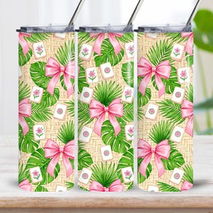 May include: Three stainless steel tumblers with lids and straws. Each tumbler has a repeating pattern of pink bows, tropical leaves, and floral game tiles on a light beige background. The design has a tropical theme.