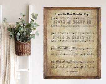 May include: A vintage-style sheet music print with the title "Angels We Have Heard on High". The sheet music is printed on aged paper with a brown background and includes lyrics and musical notation.
