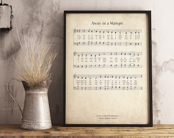 May include: A vintage-style printable sheet music for the Christmas carol "Away in a Manger". The lyrics and music are printed in black ink on a cream-colored background. The title "Away in a Manger" is printed in a larger font size at the top of the page. The lyrics are by James Montgomery and the music is by Regent Square.