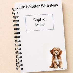 May include: White spiral-bound notebook with the text "Life Is Better With Dogs" at the top. A rectangular box contains the name "Sophia Jones". A watercolor illustration of a small, brown and white dog is at the bottom.