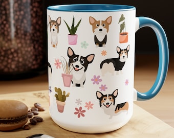 May include: White ceramic mug with a blue rim and handle. The mug features a repeating pattern of cartoon corgis, potted plants, and flowers.