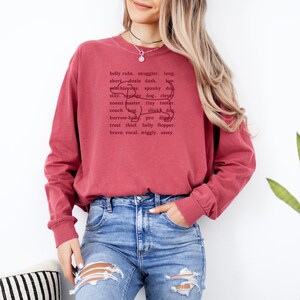 monochromatic design on comfort colors 
long sleeve tshirt with a word collage featuring an outline of a dachshund in background
