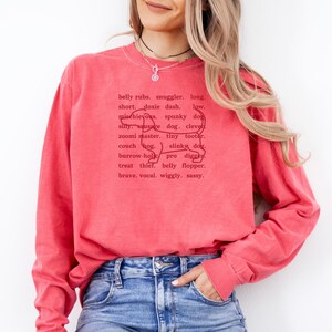 monochromatic design on comfort colors 
long sleeve tshirt with a word collage featuring an outline of a dachshund in background