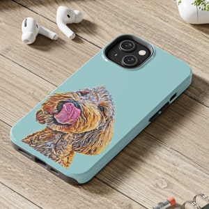 May include: A light blue phone case with a brown and white dog illustration. The dog is sticking its tongue out and has a playful expression.