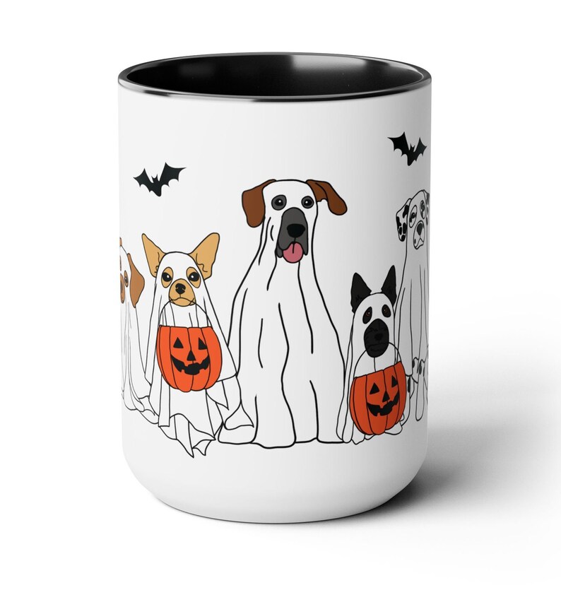 halloween ghost dog mug with a row of dogs in ghost costumes some carrying pumpkins and two black bats above them black interior and black handle 15 oz ceramic mug