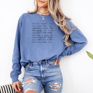 monochromatic design on comfort colors 
long sleeve tshirt with a word collage featuring an outline of a dachshund in background