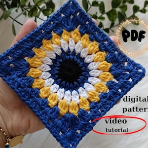 May include: A blue crochet square with a white, yellow, and black eye design in the center. The text "PDF", "digital pattern", and "video tutorial" is visible in the image.