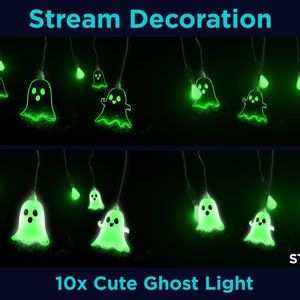 May include: A string of 10 glowing green ghost lights with cute faces. The lights are hanging from a black wire and are against a black background. The text "STYLE 04" and "10x Cute Ghost Light" are at the bottom of the image.