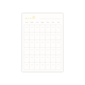 以下が含まれることがあります： 上部に金色の文字で「月」と書かれた、空白の月間カレンダープランナー。カレンダーには、日曜日から土曜日までの曜日ごとにスペースがあります。