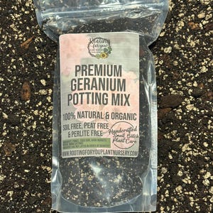 May include: A clear plastic bag filled with a dark brown potting mix for geraniums. The bag has a white label with the text "Rooliva for you Plant Nursery", "PREMIUM GERANIUM POTTING MIX", "100% NATURAL & ORGANIC", "SOIL FREE, PEAT FREE & PERLITE FREE", "Handcrafted Small Batch Plant Care", and "WWW.ROOTINGFORYOUPLANTNURSERY.COM".