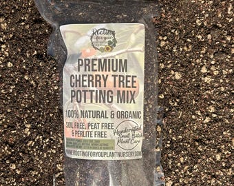 May include: A clear plastic bag filled with a dark brown potting mix for cherry trees. The bag has a white label with the text "Rooting for you Plant Nursery" and "Premium Cherry Tree Potting Mix". The label also states that the mix is 100% natural and organic, soil free, peat free, and perlite free. It is handcrafted in small batches.