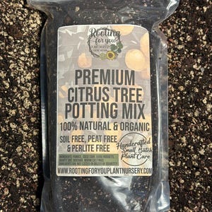 May include: A clear plastic bag filled with a dark brown potting mix for citrus trees. The bag has a label that reads "Premium Citrus Tree Potting Mix 100% Natural & Organic Soil Free, Peat Free & Perlite Free Handcrafted Small Batch Plant Care WWW.ROOTINGFORYOUPLANTNURSERY.COM".